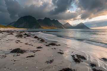 Wall Mural - Scenic view of rocky beach with mountains and sea in background