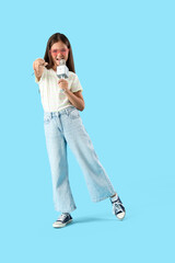 Sticker - Little girl with microphone singing on blue background