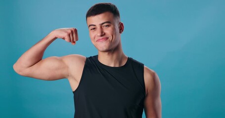 Wall Mural - Face, flexing arms and man with smile, fitness and happiness on blue studio background. Portrait, person and model with bicep, strength or wellness with energy, proud or workout with results or power