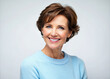 © Adisorn - Smiling happy woman in her 40s wearing sky blue sweater with short brown hair on white background.