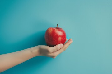 hand holding red apple