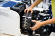 © Jintana - Technician open cover printer for replace drum and fix repair problem ink cartridges in office workplace.