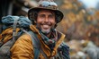 © Igal - A smiling hiker with a backpack takes a selfie outdoors, capturing a self-portrait with a bright filter.