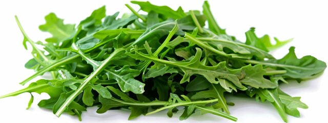  A white table holds two piles of green, leafy vegetables