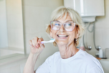 Wall Mural - woman tooth bathroom toothbrush hygiene senior morning routine brushing toothpaste care dental elder
