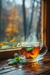 © Obsidian - Cup of hot steamy tea with mint on the windowsill in autumn