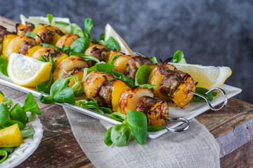 Wall Mural - Grilled lamb, yellow peppers and baby potato skewers with green leaf salad