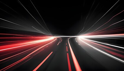 A long exposure shot of a winding road with car headlights creating streaks of red and white light against a dark background. The image captures the speed and movement of traffic.