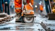 © Humeyra - Construction workers use diamond blade saws to cut concrete sidewalks