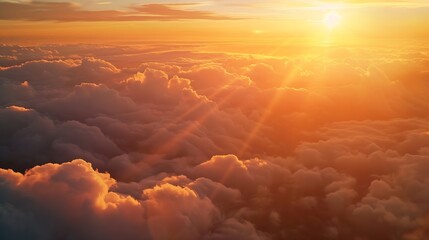 Wall Mural - an aerial shot above beautiful sunset clouds with sun shining on horizon detailed picturesque view a