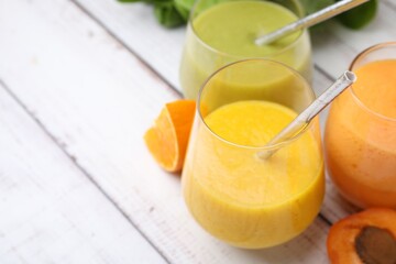 Wall Mural - Tasty smoothies in glasses and ingredients on wooden rustic table, closeup. Space for text