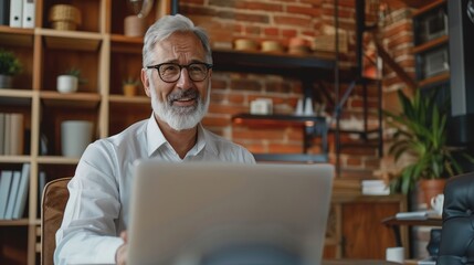 Poster - Happy mature business man executive manager looking at laptop computer watching online webinar or having remote virtual meeting, video conference call negotiation