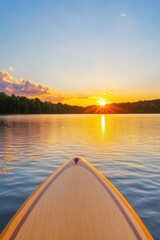 Wall Mural - Golden sunset reflected on calm lake from paddleboard at dusk