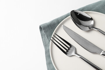 Wall Mural - Stylish silver cutlery, plate and napkin on white background, top view. Space for text