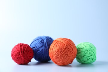 Poster - Different colorful yarns on light background. Space for text