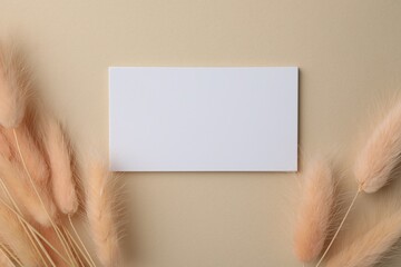 Wall Mural - Blank business cards and dried plants on beige background, flat lay. Mockup for design