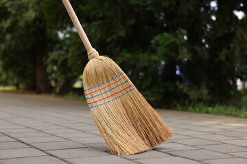 Wall Mural - One corn straw broom on pavement outdoors