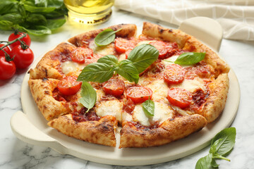 Wall Mural - Delicious Margherita pizza and ingredients on white marble table