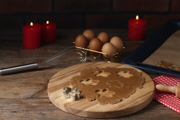 Canvas Print - Raw dough, cookie cutter, whisk, eggs and burning candles on wooden table