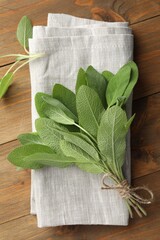 Poster - Bunch of green sage leaves on wooden table, top view