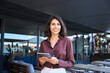 © Stock 4 You - Portrait of middle eastern businesswoman using tablet pc app for work standing at office business building outdoors. Smiling indian or latin hispanic woman holding digital computer, looking at camera