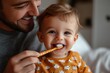 © Harvinder - Father brushing little baby boy's teeth in the morning. Morning dental hygiene for toddlers, Generative AI