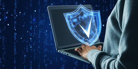 Canvas Print - Cyber security concept with shield icon on laptop screen in digital environment.