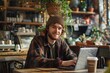 © Kishan - Happy freelancer working remotely with a laptop in a cafe, Generative AI