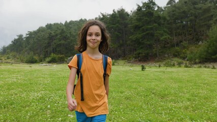 Wall Mural - Adventures and travel. a little boy with a backpack walks along a forest path. trips with children. child in the forest.