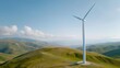 © K-MookPan - Single wind turbine standing tall on a grassy hilltop against a clear blue sky.