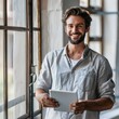 © AIGen - Standing With Tablet. Young Businessman Smiling Working Online in Modern Office