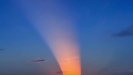 Wall Mural - a timelapse of the eclipsed suns journey across the sky tracing its path with a bright orange light.