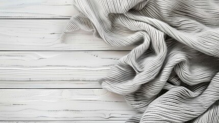 Gray soft textile material on white wooden table as background or desktop wallpaper