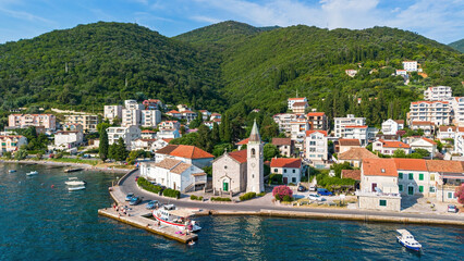 Wall Mural - Aerial view of the waterfront orthodox church of Saint Roch of Donja Lastva in Tivat in the Bay of Kotor, Montenegro