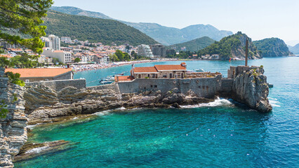 Wall Mural - Aerial view of the Kastio Castle built on a peninsula in Petrovac na Moru, a resort town located on the coast of the Adriatic Sea in Montenegro