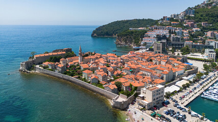 Wall Mural - Aerial view of the Old Town of Budva, built on a peninsula along the coast of the Adriatic Sea in Montenegro - Walled coastal city built by the Venetian Republic