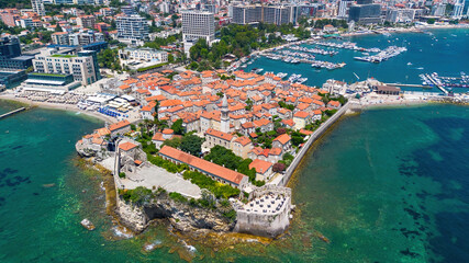 Wall Mural - Aerial view of the Old Town of Budva, built on a peninsula along the coast of the Adriatic Sea in Montenegro - Walled coastal city built by the Venetian Republic