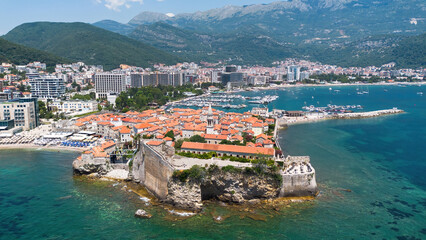 Wall Mural - Aerial view of the Old Town of Budva, built on a peninsula along the coast of the Adriatic Sea in Montenegro - Walled coastal city built by the Venetian Republic