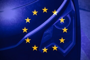 Front view of a car with the flag of Europe as background.