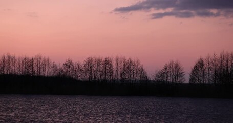 Wall Mural - yellow sun on the lake at sunset, beautiful orange sky at sunset in spring