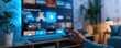 © SITTAKAN - A person selecting a streaming app on a smart TV