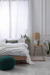 © New Africa - Stylish living room interior with bed, bedside table, lamp and houseplants