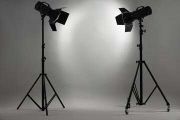 Wall Mural - Grey photo background and professional lighting equipment in studio