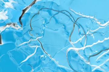 Wall Mural - Macro shot of thin layer of frozen ice surface on blue background