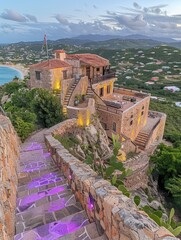 Wall Mural - Captivating hilltop Mediterranean villa with stone staircase and vibrant lighting overlooking coastal scenery at sunset