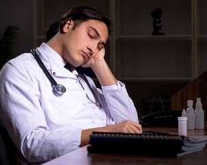 Wall Mural - Young male doctor in the hospital at night