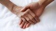 © CHOI POO - Gentle Touch of Care: Elderly hand held by younger hand, signifying love, support, and comfort.  A tender image of intergenerational connection.