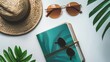 © Galib - A flat lay of summer essentials: a straw hat, sunglasses, and a notebook with tropical leaves.