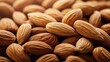 © pinporn manosri - Detailed close-up of a pile of almonds, with smooth surfaces and natural brown tones, perfect for a healthy eating background