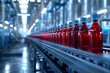 © Piyaphorn - Rows of juice bottles traveling on a conveyor belt through a beverage factory with a blue industrial interior, emphasizing the cleanliness and efficiency of the process.